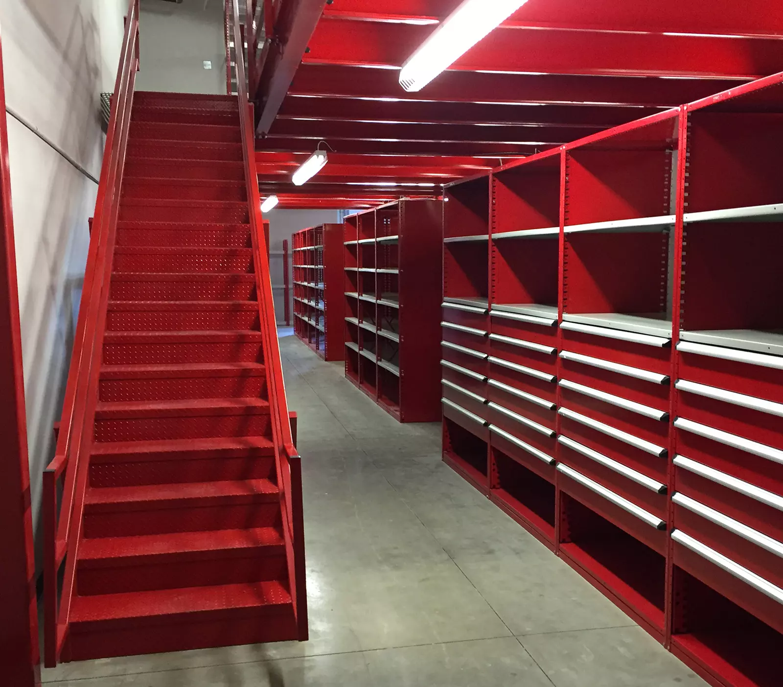 Automotive Parts Department with Drawers in Shelving, Modular Drawer Cabinets, and Stairs to Mezzanine