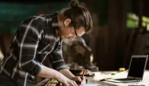 Man working on butcher block top Workbench in workshop