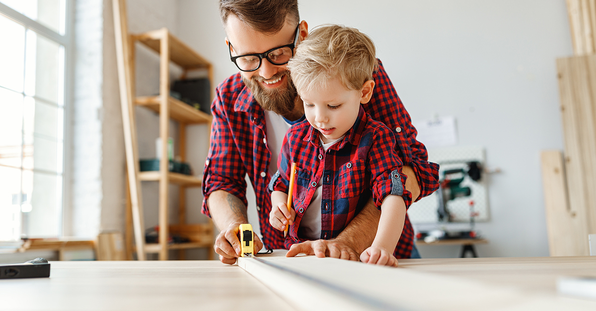 Man and Child working in Workroom on Workbench